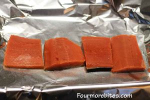 Salmon fillets on a foil lined baking sheet