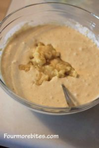 Adding mashed bananas to pancake batter