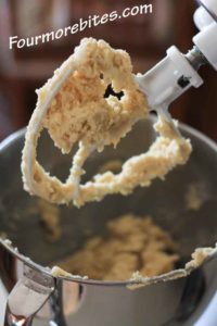 Lemon sugar cookie dough in a stand mixer with a paddle attachment