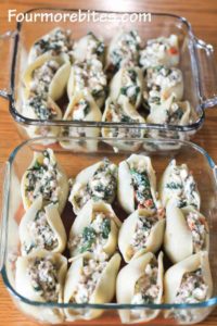 Jumbo pasta shells stuffed with spinach, meat and cheese mixture in two 8x8 glass pans