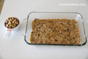 Pecan crust pressed into glass pan with 3/4 cup reserved for topping