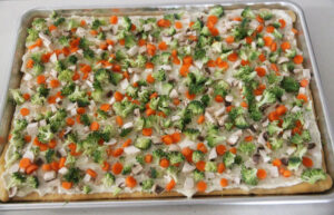 Broccoli sprinkled on veggie pizza