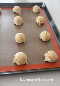 White Chocolate Macadamia Nut Cookies scooped onto a silpat lined cookies sheet.